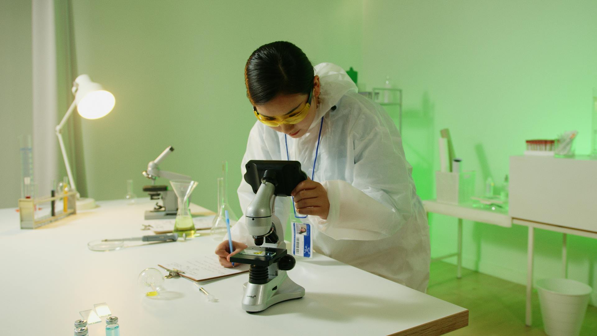 Medical school professor at front of classroom holding model of brain